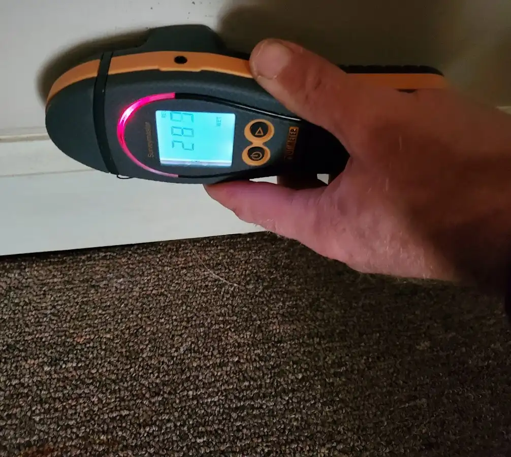 Moisture detection at baseboard during Storm Damage Restoration in Chatham